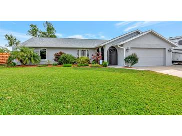 Well-maintained single story home with a spacious lawn and attached garage at 2154 Lakewood Dr, Nokomis, FL 34275