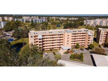 Aerial view of a condo building with parking and landscaping at 4570 Pinebrook Cir # 303, Bradenton, FL 34209