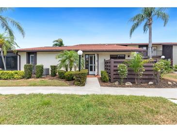 Inviting condo exterior featuring a private entrance and well-manicured landscaping at 5400 34Th W St # D12, Bradenton, FL 34210