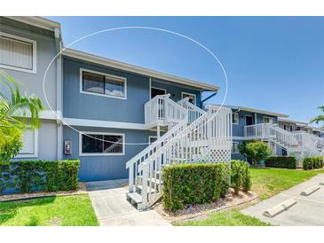 Exterior view of a condo building with stairs and landscaping at 6033 34Th W St # 120, Bradenton, FL 34210