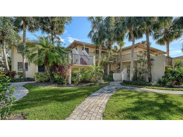 Condo building with palm trees and brick walkways at 6450 Wild Oak Bay Blvd # 238, Bradenton, FL 34210