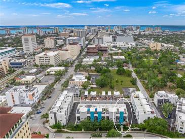 Aerial view of modern townhouses with city skyline in background at 72 N School Ave, Sarasota, FL 34237