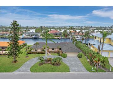 Aerial view of waterfront home with pool and landscaped yard at 740 Old Compass Rd, Longboat Key, FL 34228