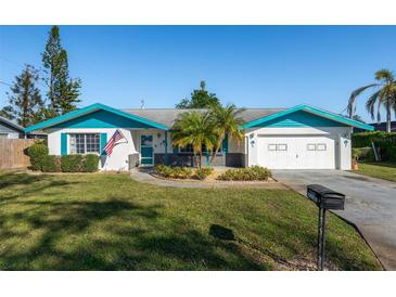 Charming single-story home with well-manicured lawn, blue trim, and attached garage at 807 62Nd W St, Bradenton, FL 34209