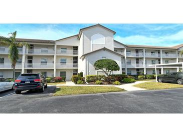 Two-story condo building with parking and landscaping at 8750 Olde Hickory Ave # 9205, Sarasota, FL 34238