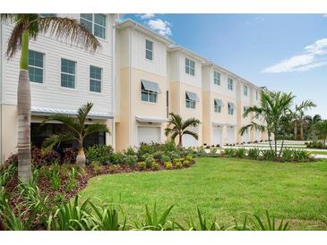 Modern townhouses with attached garages and landscaped lawns at 9985 Key Haven Rd, Seminole, FL 33777
