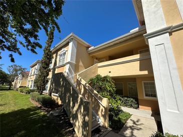 Exterior view of condo building showcasing building facade and landscaping at 1010 Villagio Cir # 207, Sarasota, FL 34237