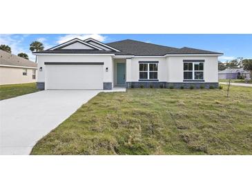 Single-story home with gray roof, white exterior, and a two-car garage at 1637 Turrell St, North Port, FL 34286