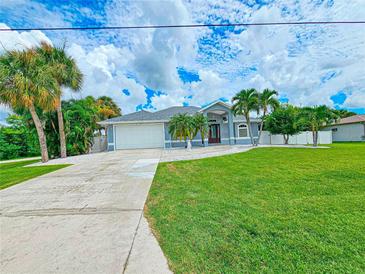 Beautiful home with a well-manicured lawn and driveway at 18652 Ohara Dr, Port Charlotte, FL 33948