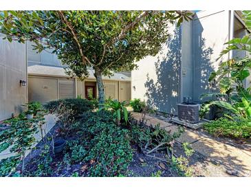 Well-manicured landscaping surrounds the entrance to this condo at 360 Pine Run Dr, Osprey, FL 34229