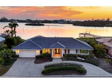 Luxury waterfront home with circular driveway, offering sunset views at 419 Yacht Harbor Dr, Osprey, FL 34229