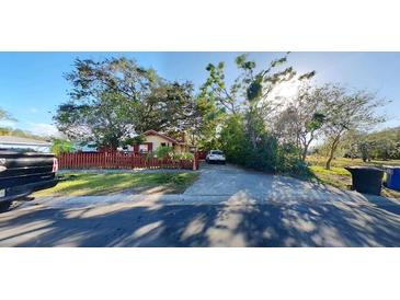 Front view of a charming house with a red fence and driveway at 4352 17Th S Ave, St Petersburg, FL 33711