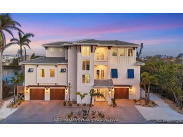 Stunning waterfront home with three-car garage and beautiful landscaping at 608 Bayview Dr, Longboat Key, FL 34228