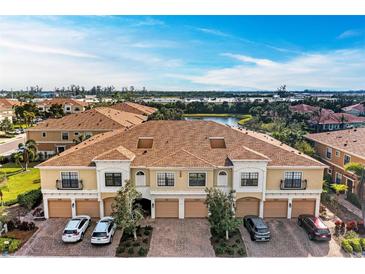 Aerial view of a townhome community with a pond at 7325 Skybird Rd, Bradenton, FL 34209