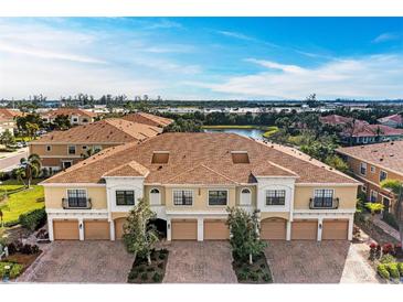 Aerial view of townhouses with lake and lush landscaping at 7325 Skybird Rd # 7325, Bradenton, FL 34209