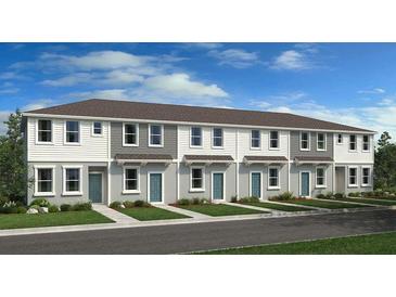 Three-unit townhome building with gray siding and teal doors at 8572 Daybreak St, Sarasota, FL 34241