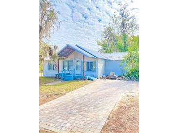 Light blue house with a new paver driveway at 10607 3Rd St, Thonotosassa, FL 33592