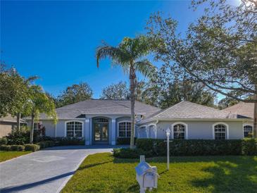 Single-story home with gray exterior, landscaping, and a two-car garage at 11264 28Th Street E Cir, Parrish, FL 34219