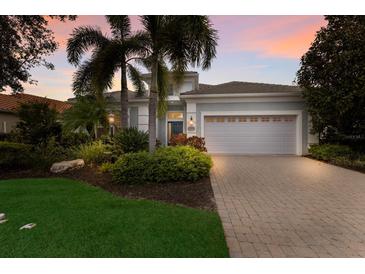 Attractive single-story home with landscaped yard and gray garage door at 14333 Stirling Dr, Lakewood Ranch, FL 34202