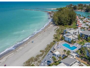 Aerial view of beachfront property with pool and lush landscaping at 1555 Tarpon Center Dr # 261, Venice, FL 34285