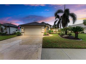 Beautiful house exterior with palm trees and a well-maintained lawn at 232 Venice Palms Blvd, Venice, FL 34292