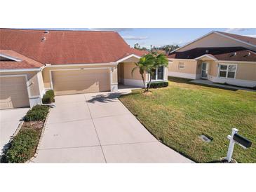 Attractive exterior of a house with a two-car garage and well-maintained lawn at 2608 Edgewater Ct, Palmetto, FL 34221