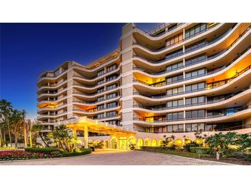 Luxury condo building exterior with well-lit entrance and landscaping at 415 L Ambiance Dr # A401, Longboat Key, FL 34228