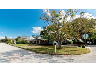 Ranch style home with a large front yard and mature trees at 5415 8Th Avenue W Dr, Bradenton, FL 34209