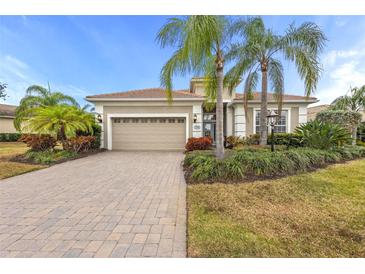 Single-story home with a two-car garage and landscaped front yard at 7204 Annanhill Ln, Lakewood Ranch, FL 34202