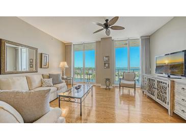 Bright living room with water views, hardwood floors, and ample natural light at 1233 N Gulfstream Ave # 502, Sarasota, FL 34236