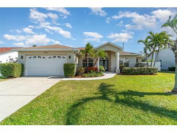 Single-story home with attached garage, landscaping, and a paved driveway at 1507 91St Nw Ct, Bradenton, FL 34209