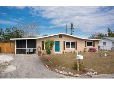 Cute ranch home with teal door, screened porch, and well-maintained lawn at 2206 25Th W Ave, Bradenton, FL 34205