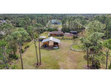 Aerial view of a house with a large fenced yard, perfect for horses at 3340 Ulman Ave, North Port, FL 34286