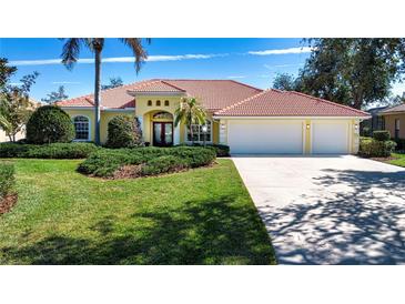 Beautiful one-story home with tile roof, three-car garage, and lush landscaping at 3716 Eagle Hammock Dr, Sarasota, FL 34240