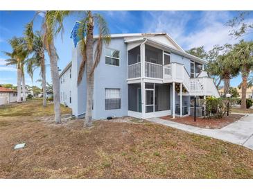 Light blue two-story condo with balcony, screened porch, and palm trees at 3815 59Th W Ave # 3815, Bradenton, FL 34210