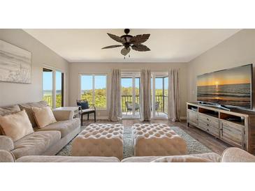 Bright living room with water views, comfy seating, and large TV at 4009 Catalina Dr # 178, Bradenton, FL 34210