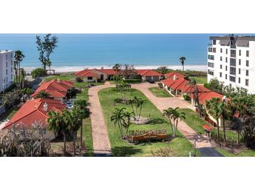 Aerial view of Pelican Harbor community, showcasing beachfront location and red tile roofs at 4239 Gulf Of Mexico Dr # Mh4, Longboat Key, FL 34228