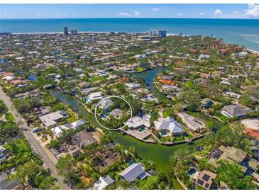 Aerial view of waterfront home with private backyard and canal access at 4857 Primrose Path, Sarasota, FL 34242