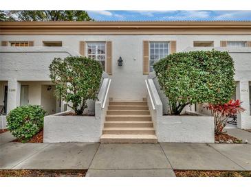 Front view of condo building with stairs and landscaping at 5248 Marshfield Ln # 2, Sarasota, FL 34235