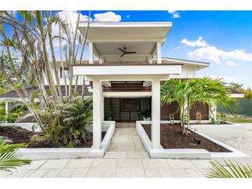 Two-story home with modern design, tropical landscaping, and walkway at 541 Edlee Ln, Longboat Key, FL 34228