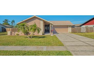 Tan house with a beige garage door and nicely landscaped lawn at 6556 Waterford Cir, Sarasota, FL 34238