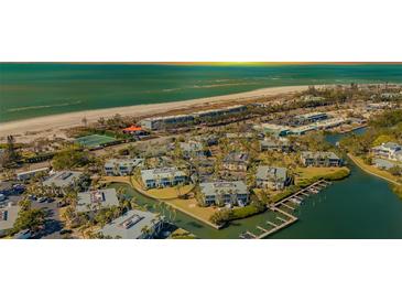 Aerial view of waterfront condo community, showcasing the property's location and surrounding landscape at 6750 Gulf Of Mexico Dr # 153, Longboat Key, FL 34228