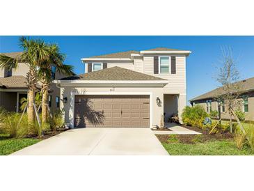 Two-story house with a brown garage door and landscaped yard at 8612 Evening Dr, Sarasota, FL 34241