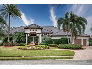 Beautiful one-story home with tile roof, fountain, and lush landscaping at 10523 Cheval Pl, Lakewood Ranch, FL 34202