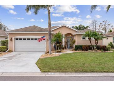Single-story home with attached garage, landscaping, and a paved driveway at 11921 Whistling Way, Lakewood Ranch, FL 34202