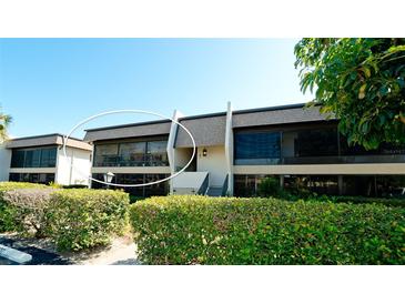 Exterior view of condo building with landscaping and balcony at 1737 Bonitas Cir # 1724D, Venice, FL 34293