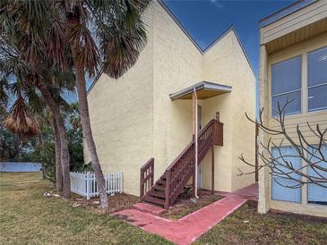 Exterior view showing building and stairs leading to condo entrance at 3407 Clark Rd # 207, Sarasota, FL 34231