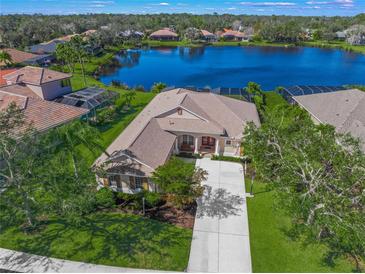 Aerial view of a single-Gathering home with a lake view in a quiet community at 4790 Sweetshade Dr, Sarasota, FL 34241