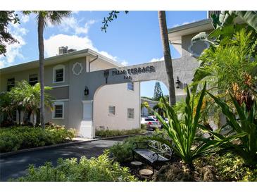 Palm Terrace 324 building exterior, featuring a landscaped entryway and parking at 521 W Venice Ave # 22, Venice, FL 34285