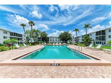 Refreshing community pool with lounge chairs at 5938 Welcome Rd # H22, Bradenton, FL 34207